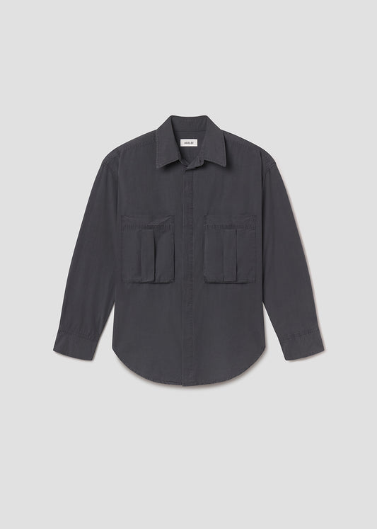 Flat lay shot of dark grey shirt with pocket details on a grey background
