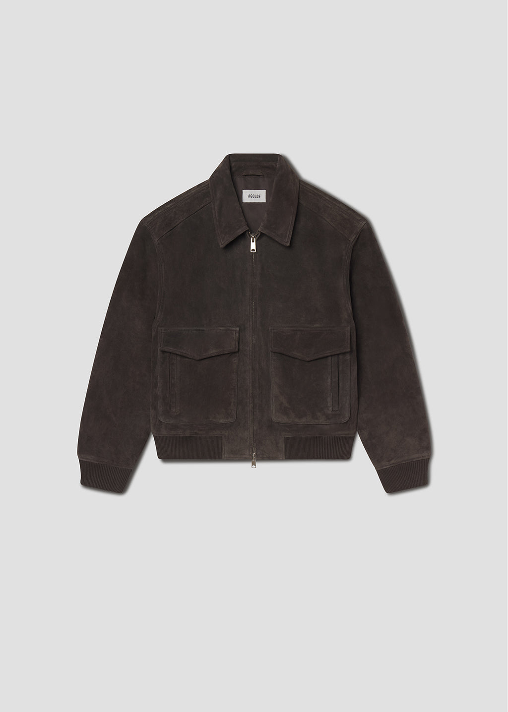 Flat lay shot of brown corduroy jacket on a grey background