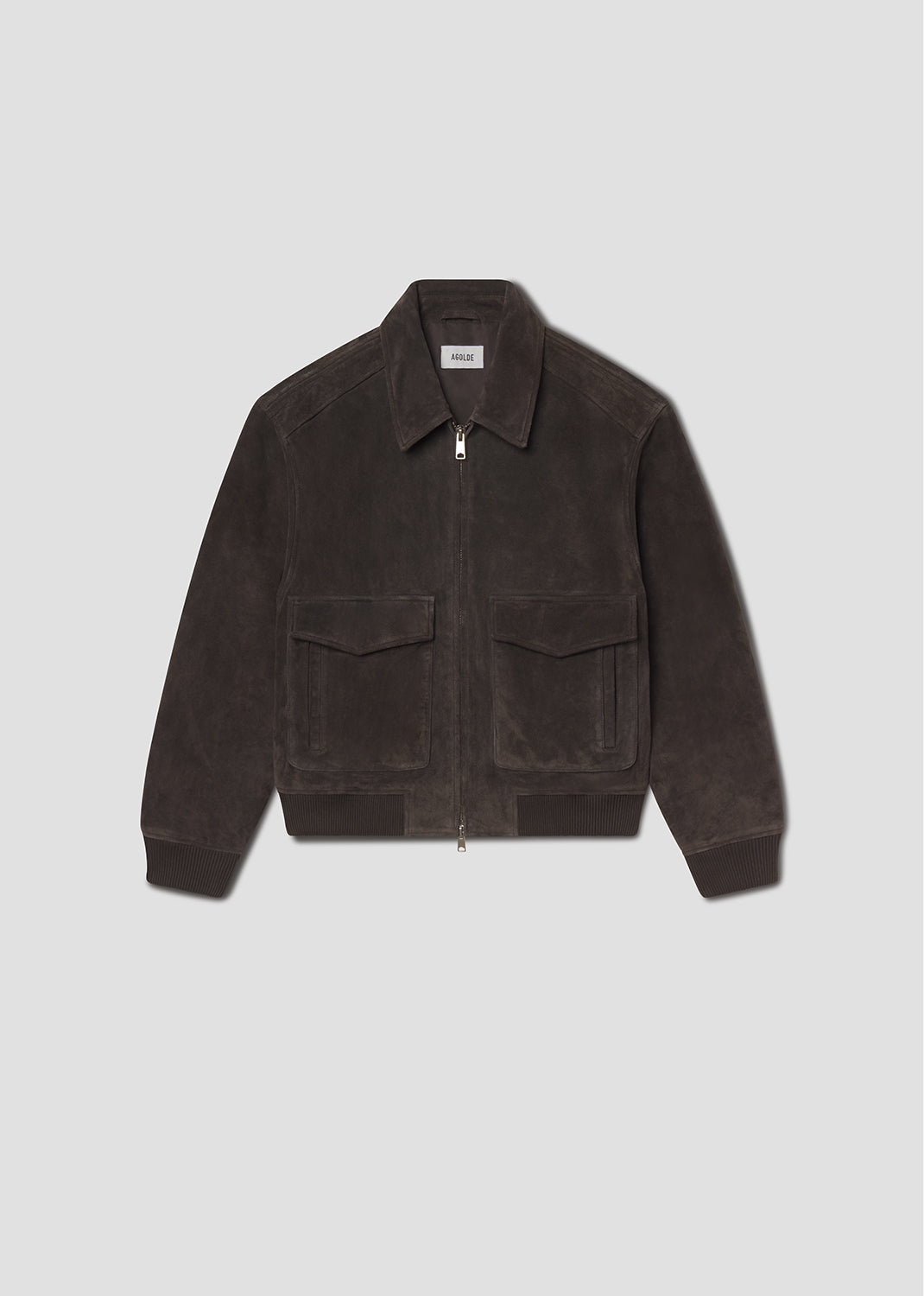 Flat lay shot of brown corduroy jacket on a grey background