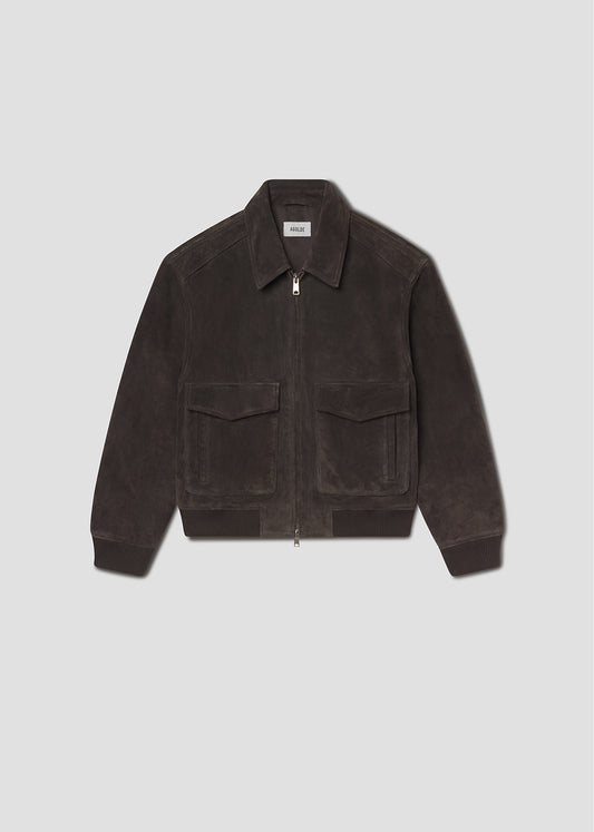 Flat lay shot of brown corduroy jacket on a grey background