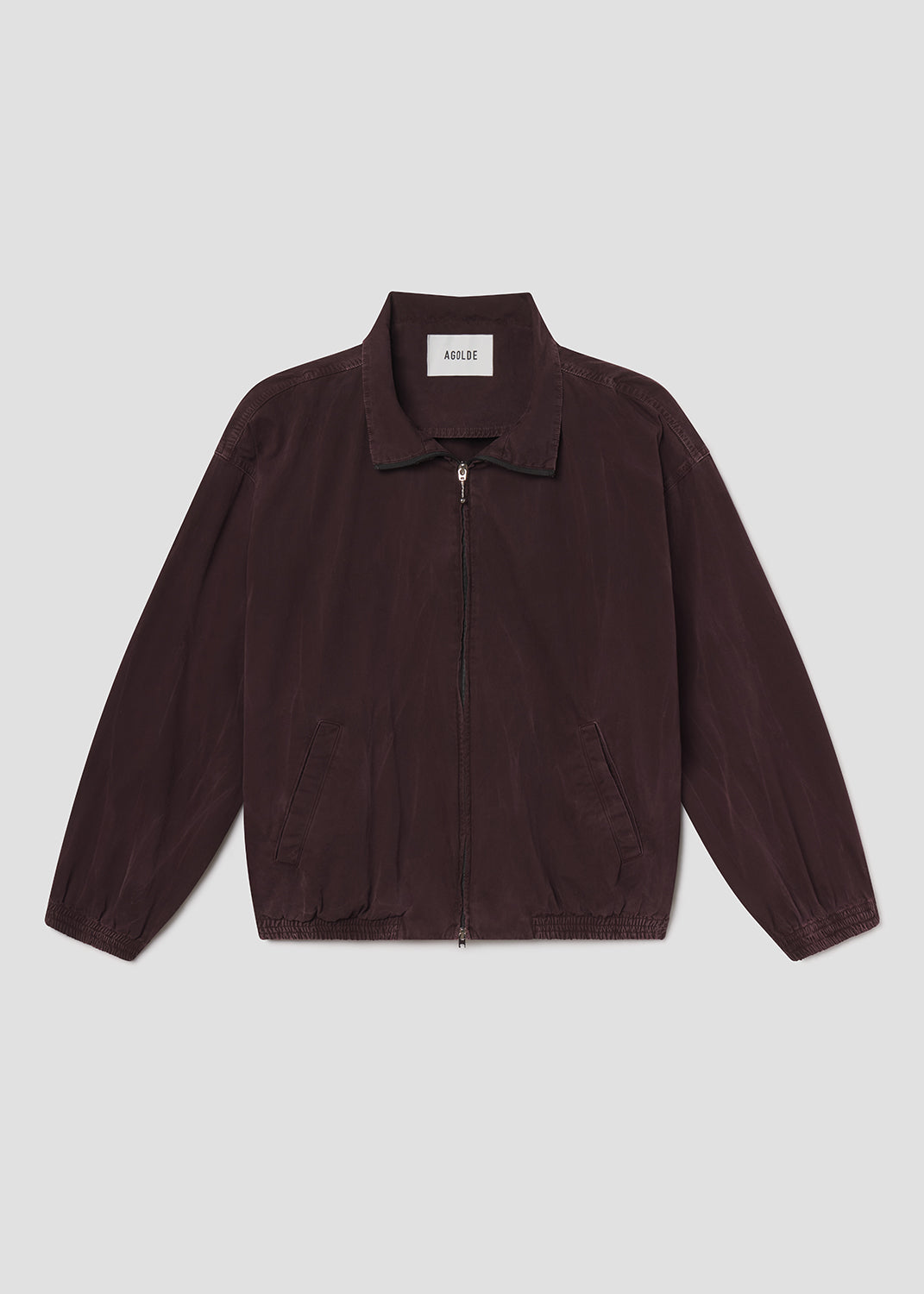 Flat lay of brown jacket on a grey background