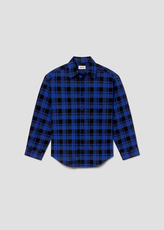 Flat lay shot of blue and black plaid shirt on a grey background