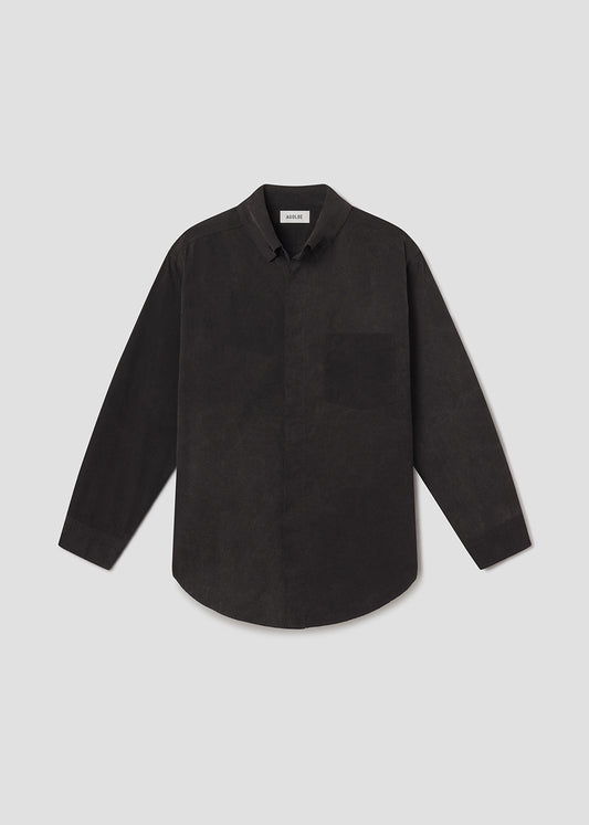 Flat lay shot of black shirt on a grey background
