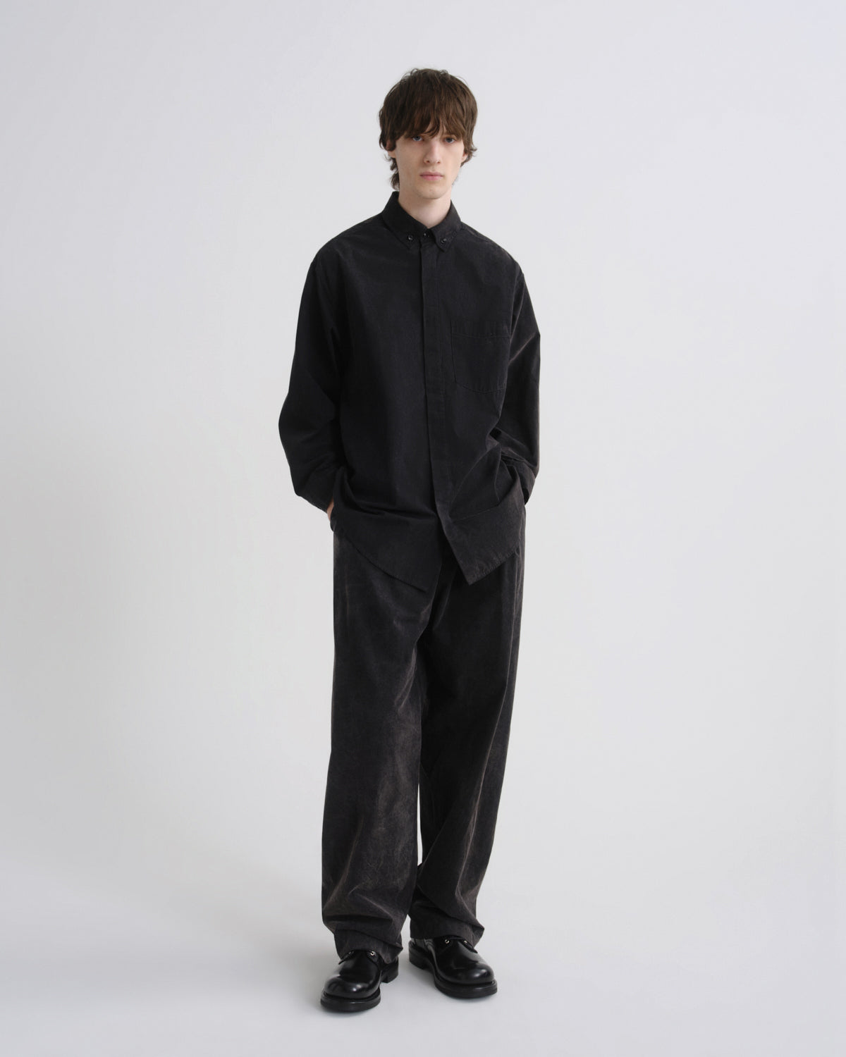 Person wearing a black outfit on a white background