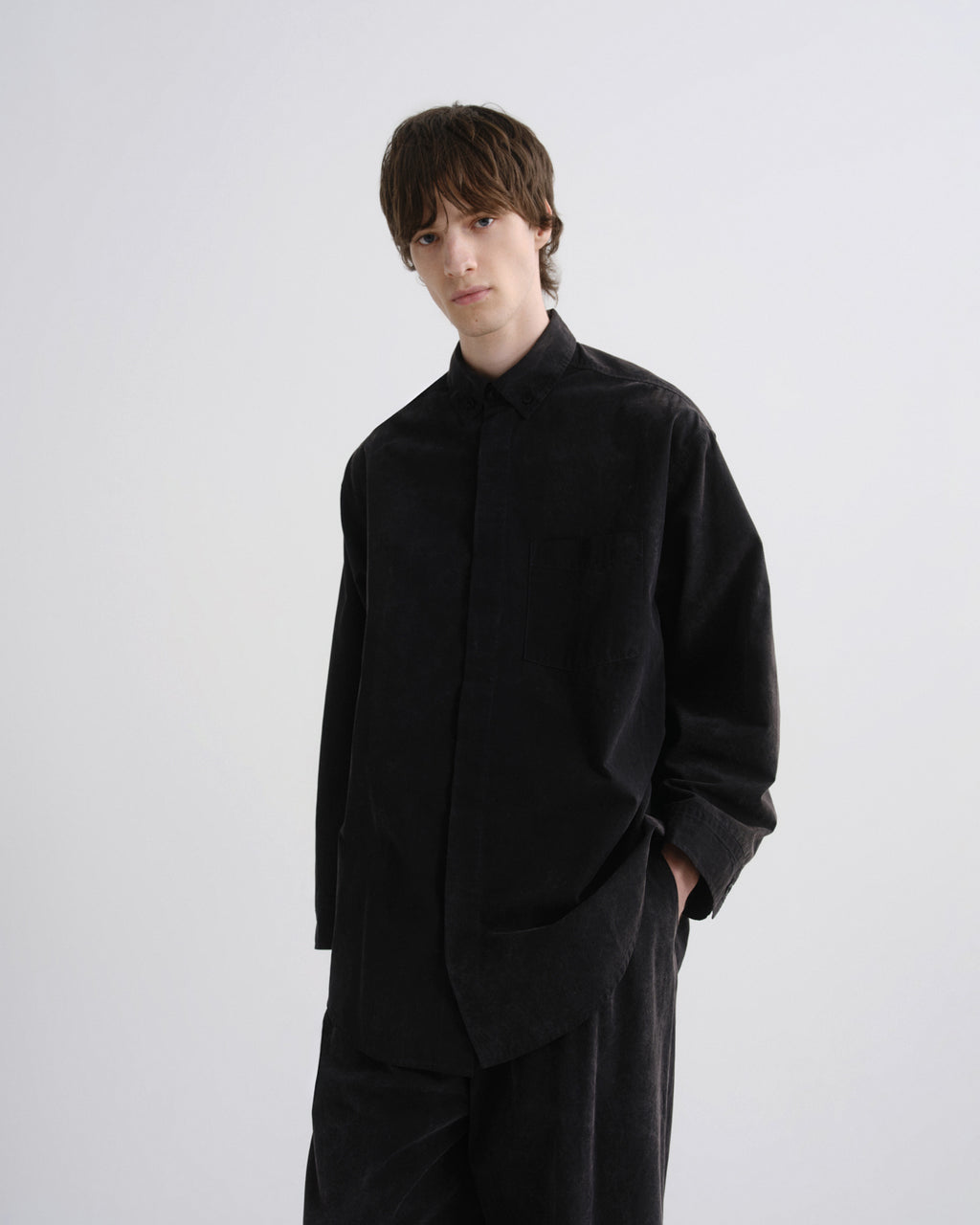 Person wearing a black outfit on a white background