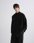 Person wearing a black outfit on a white background