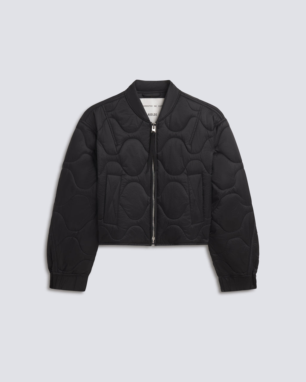A black quilted bomber jacket with a unique wavy circular quilting pattern, shown flat on a light gray background.