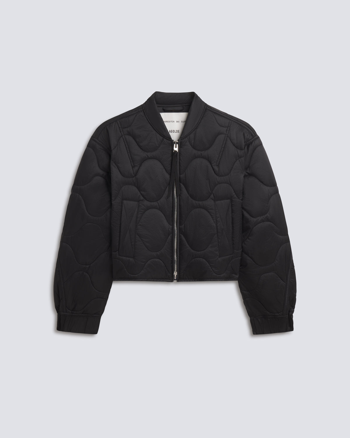 A black quilted bomber jacket with a unique wavy circular quilting pattern, shown flat on a light gray background.