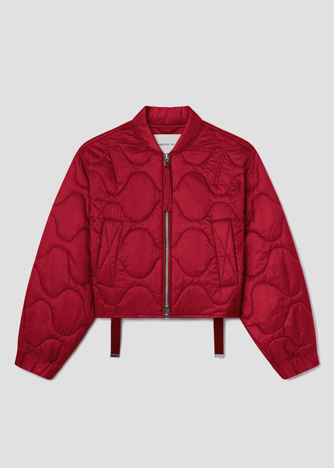 Red quilted jacket on a light gray background