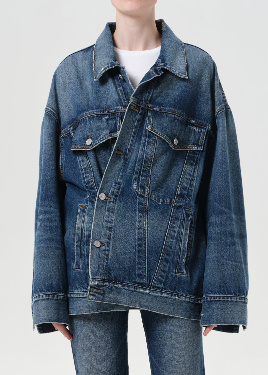 Blue denim jacket worn by a person on a white background