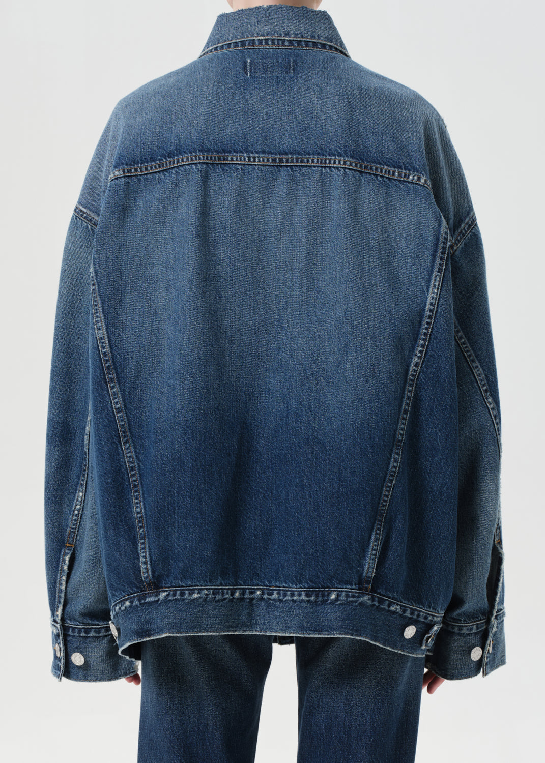 Blue denim jacket on a plain background