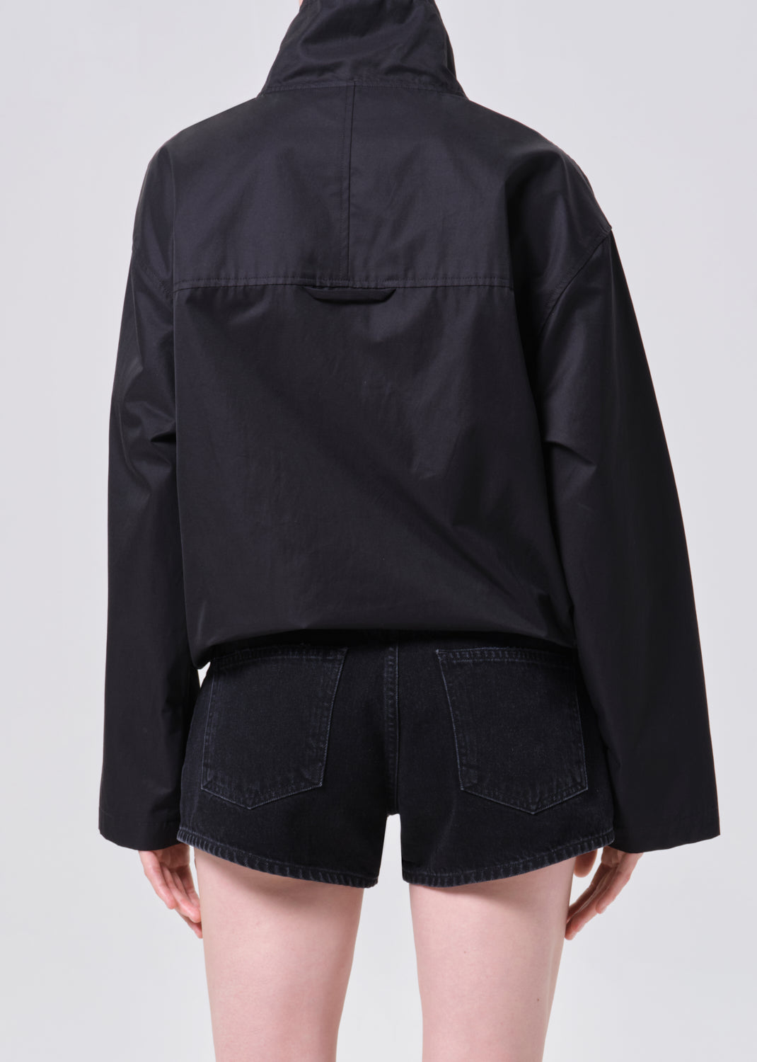 Black jacket and shorts on a plain background