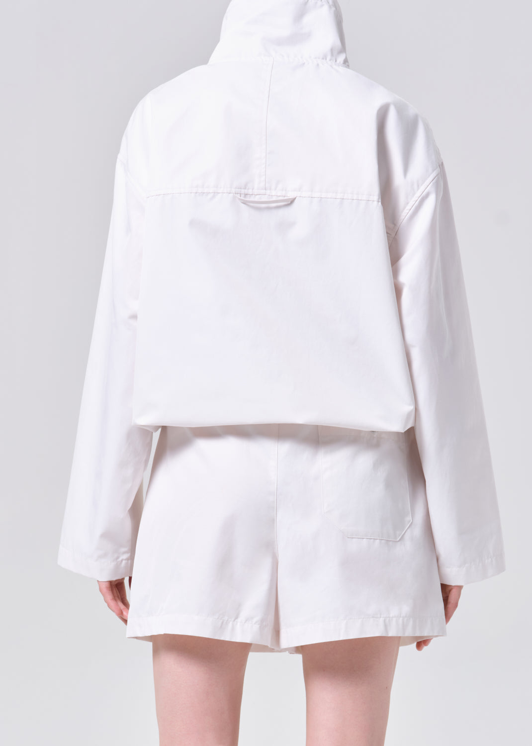 White jacket and shorts set on a plain background