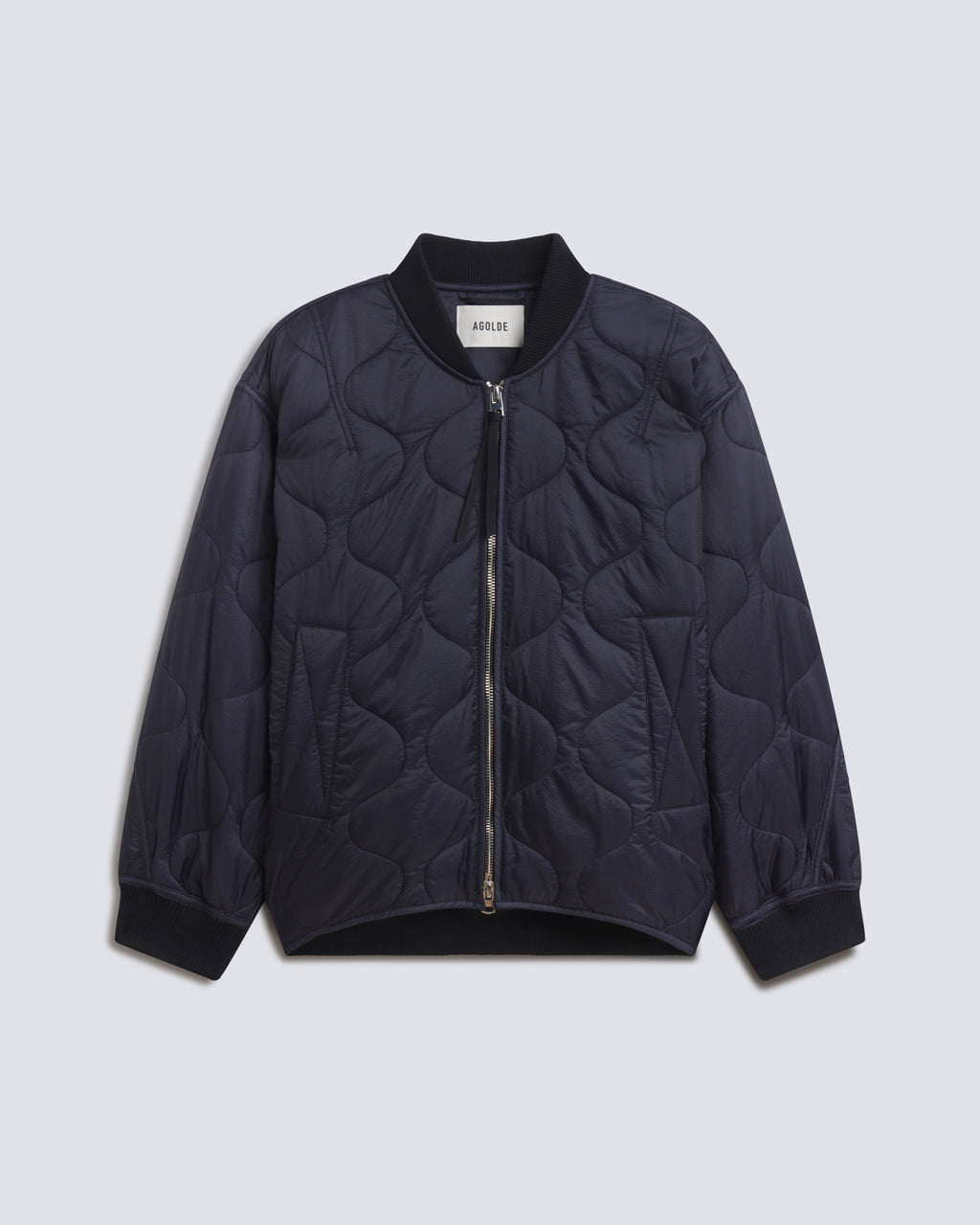 A dark navy blue quilted bomber jacket with a front zipper, ribbed collar, cuffs, and hem, displayed flat against a light gray background.