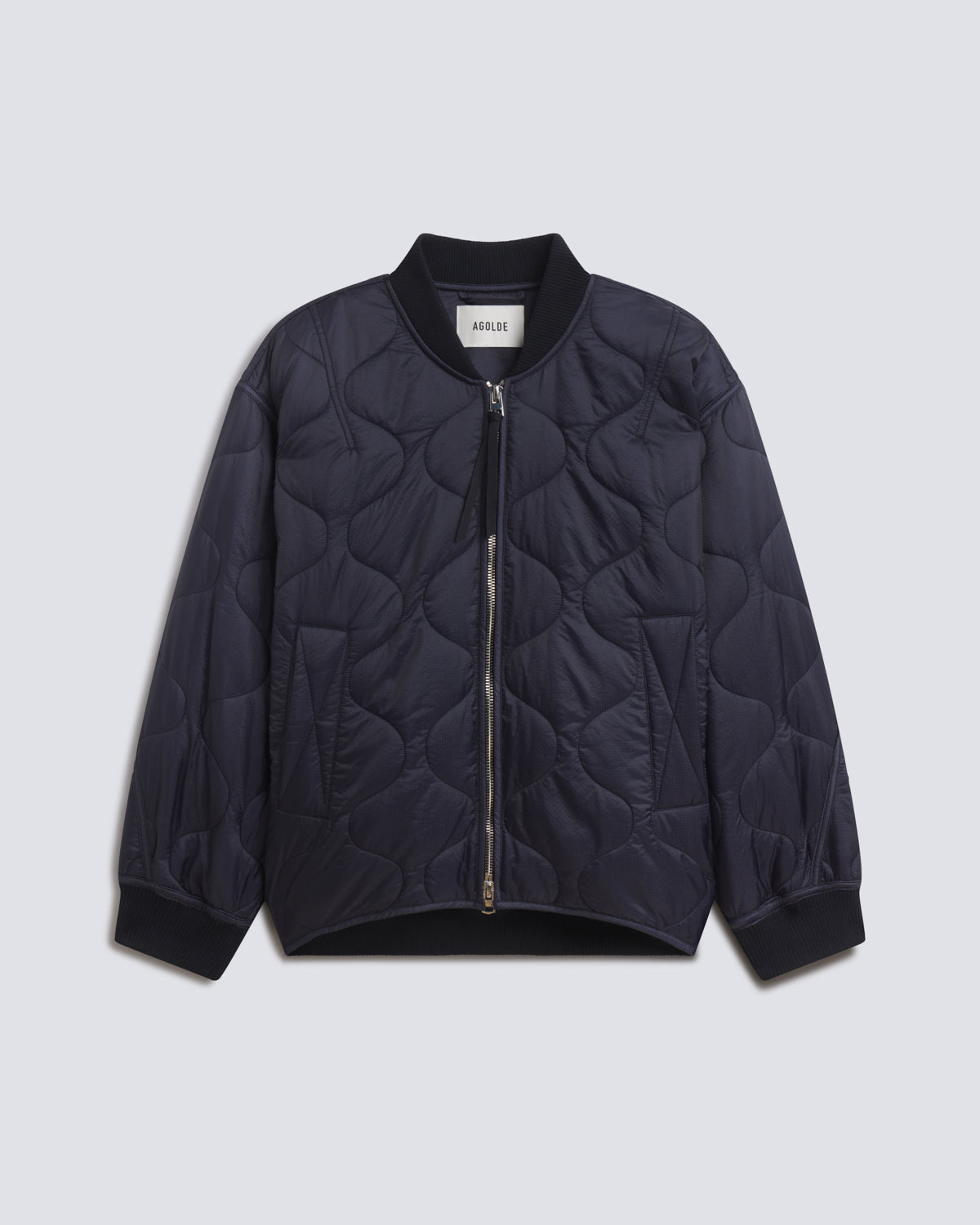 A dark navy blue quilted bomber jacket with a front zipper, ribbed collar, cuffs, and hem, displayed flat against a light gray background.