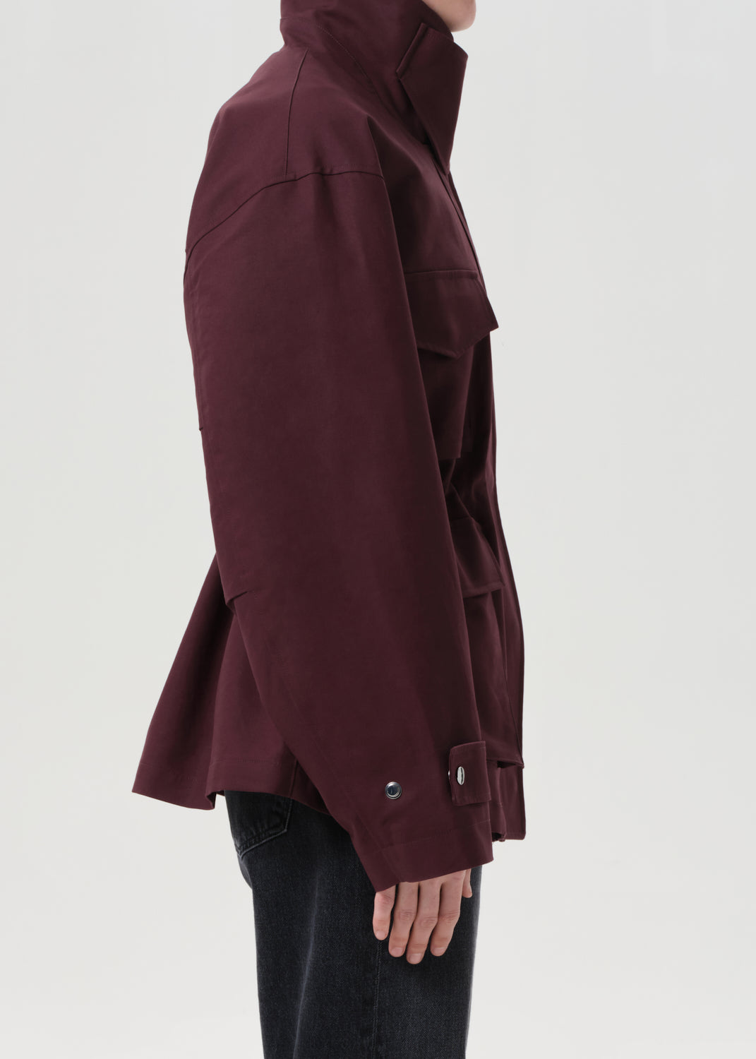 Maroon jacket worn by a person on a white background