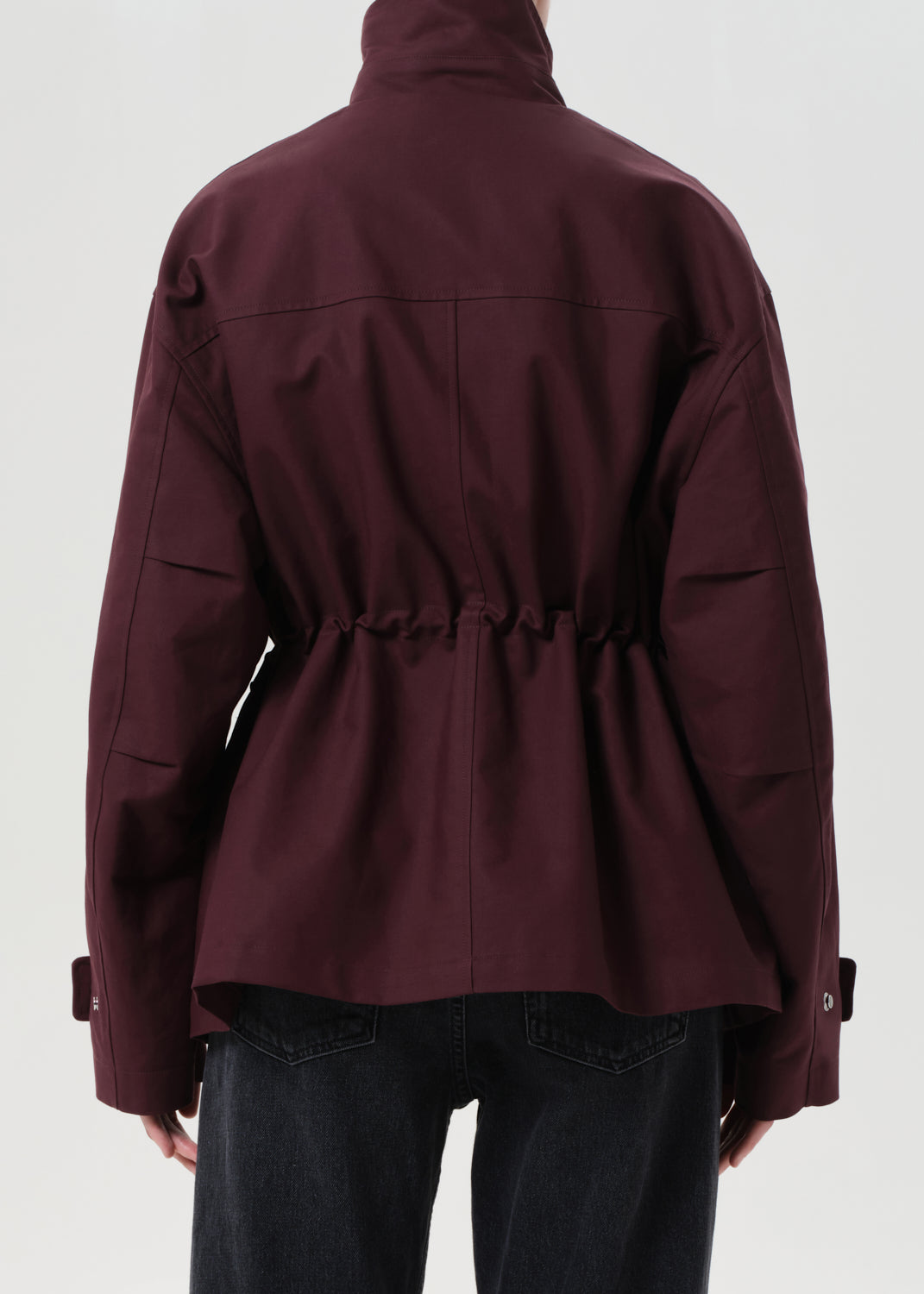 Maroon jacket worn by a person on a white background