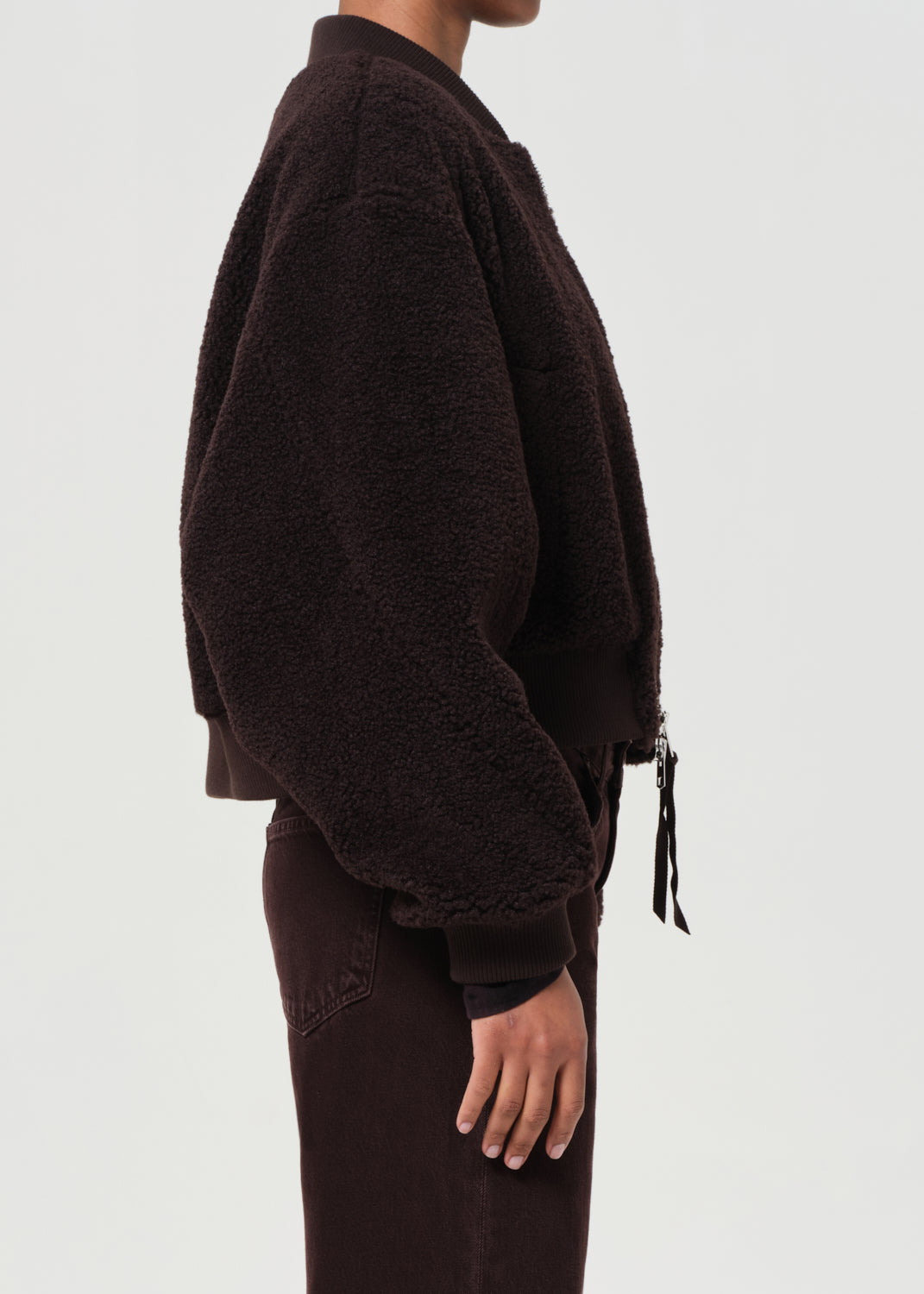 Brown fleece jacket worn by a person on a white background