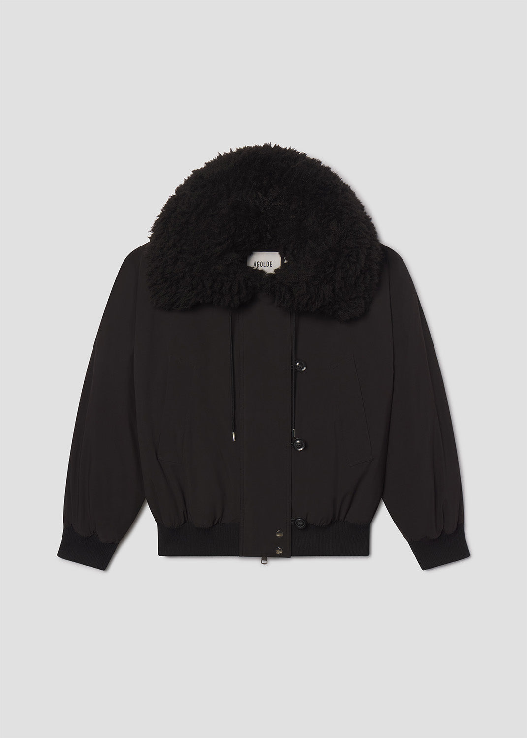 Black jacket with fur hood on a light gray background