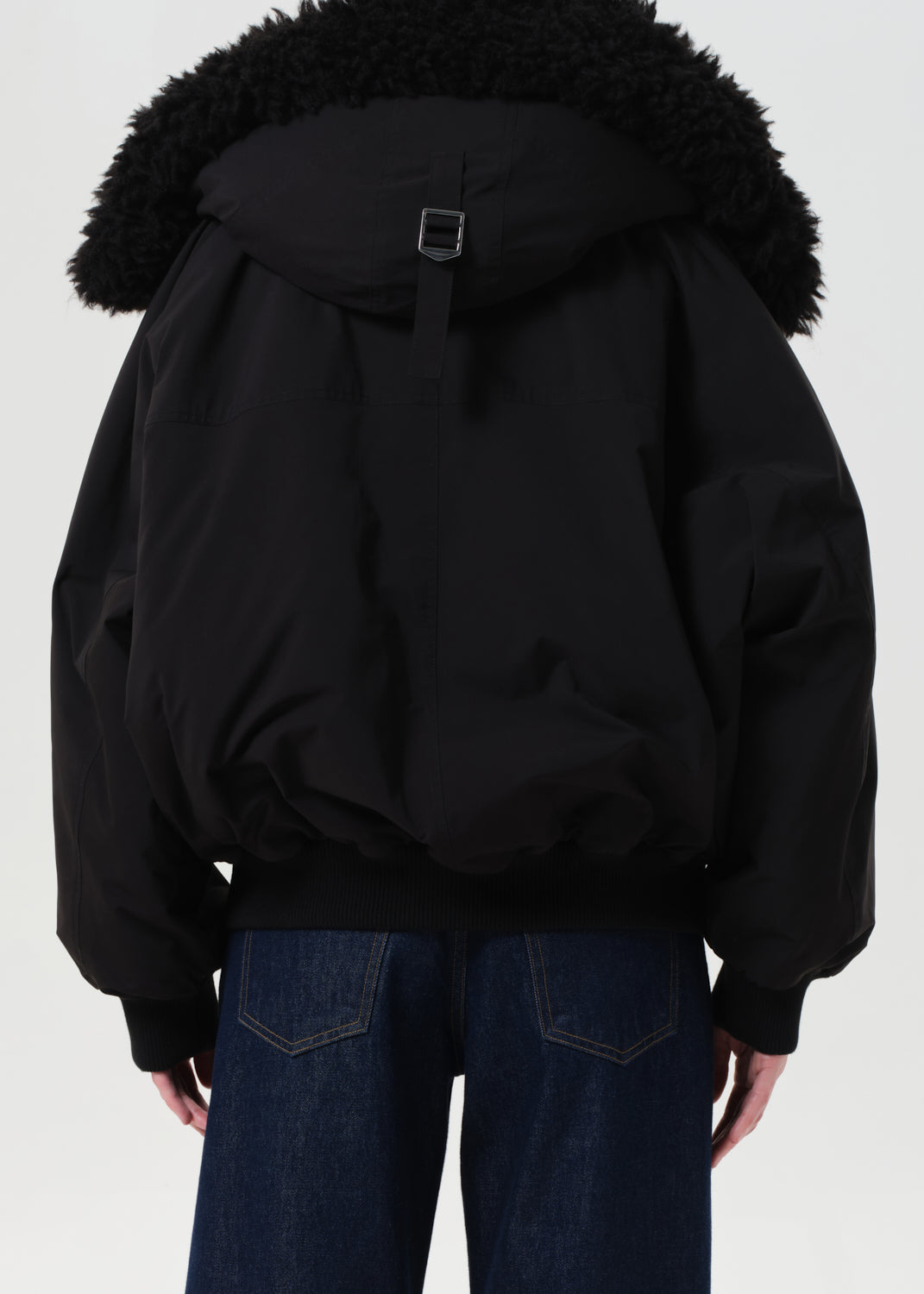 Black jacket with fur-lined hood on a plain background
