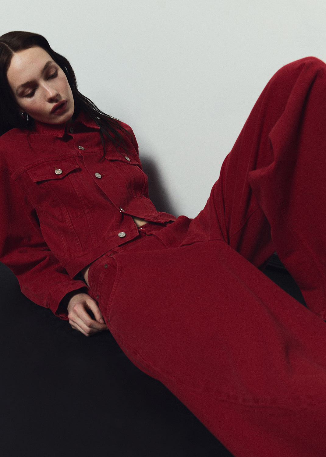 Person wearing a red outfit against a plain background