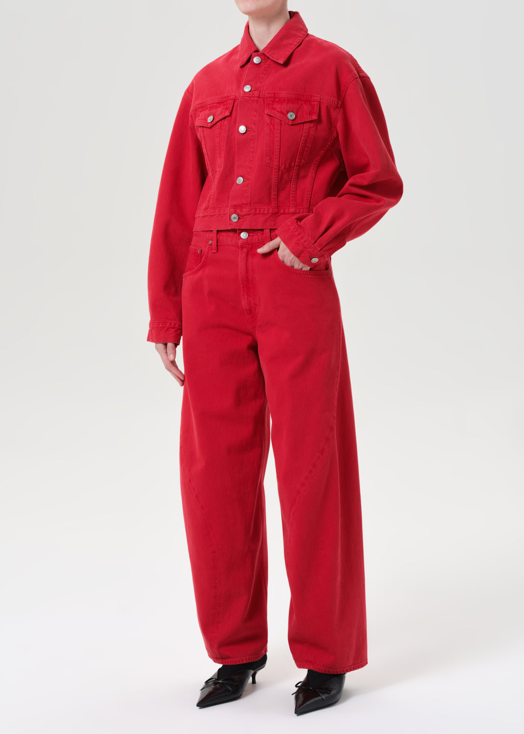 Person wearing a red jumpsuit on a white background