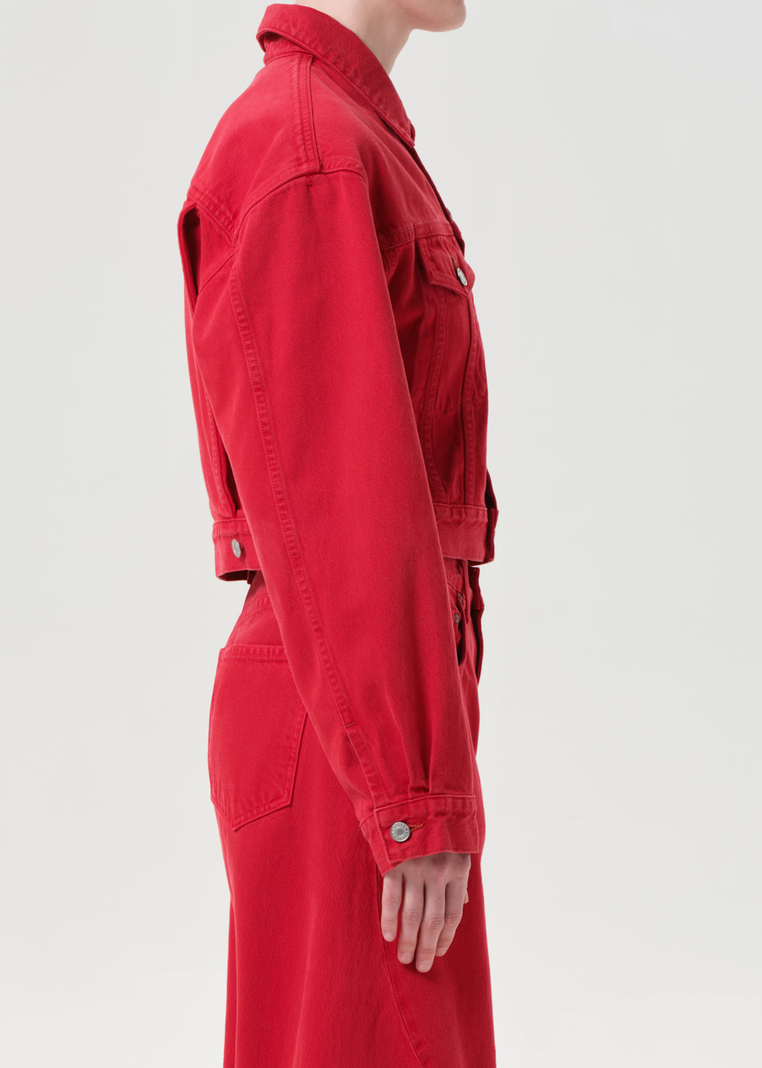 Red jumpsuit worn by a person on a light gray background