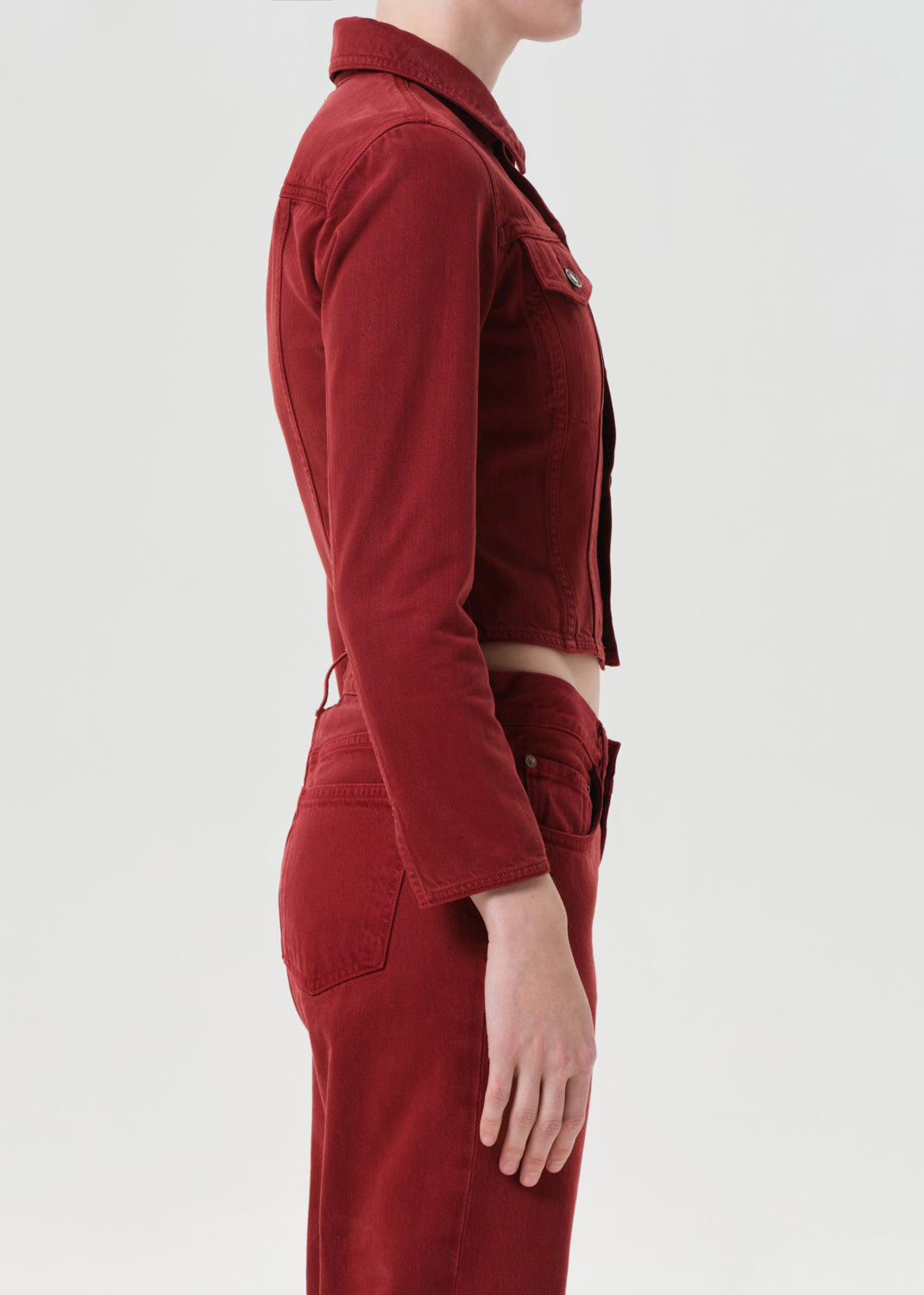Red jumpsuit worn by a person on a light gray background