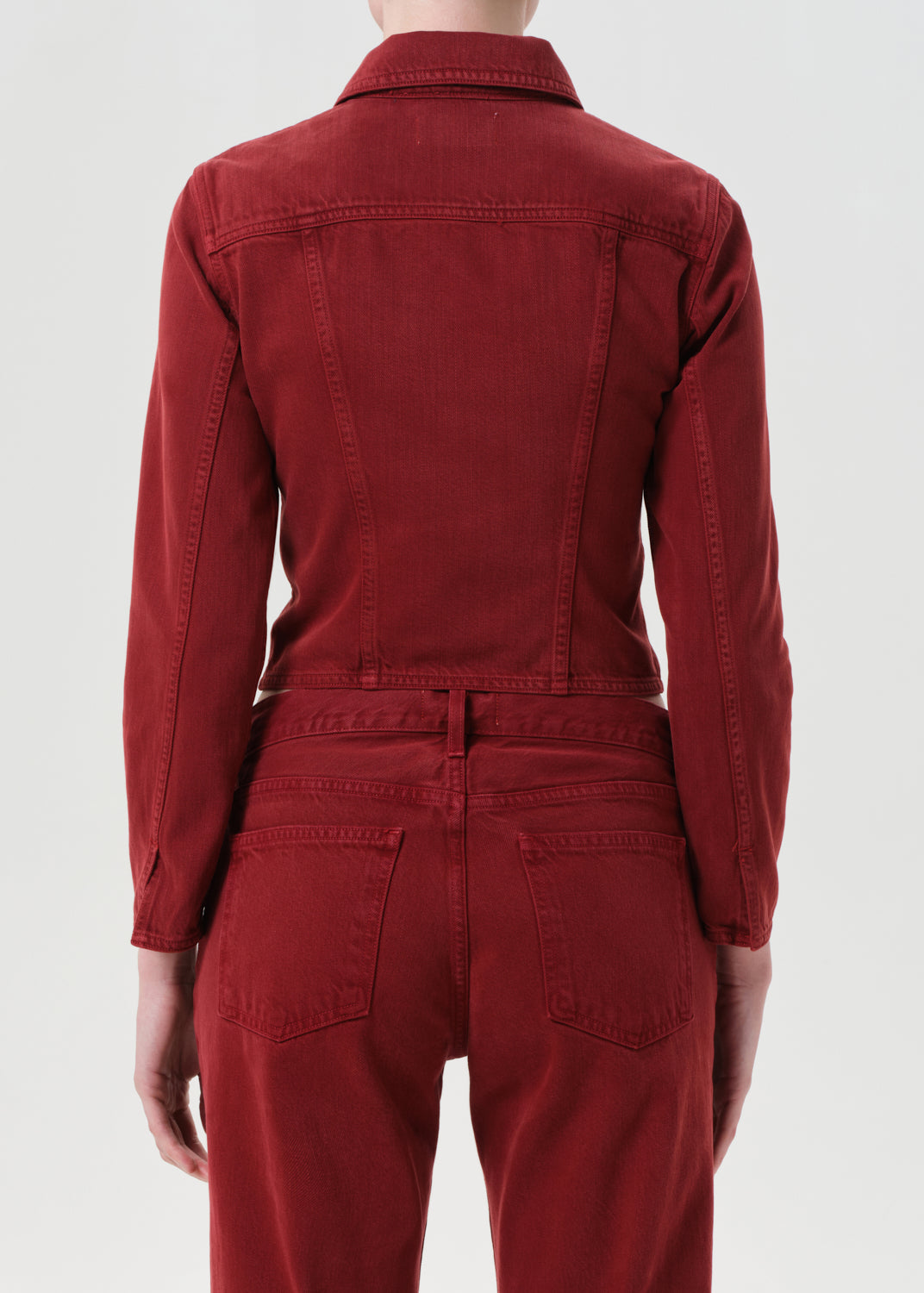 Red jumpsuit worn by a person on a white background