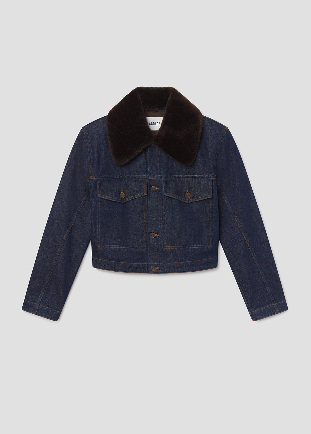 Denim jacket with black fur collar on a light gray background