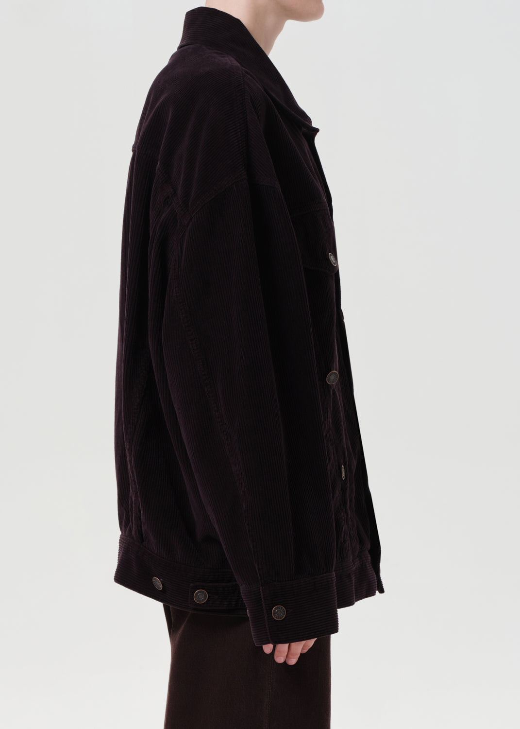 Dark brown jacket worn by a person on a light gray background