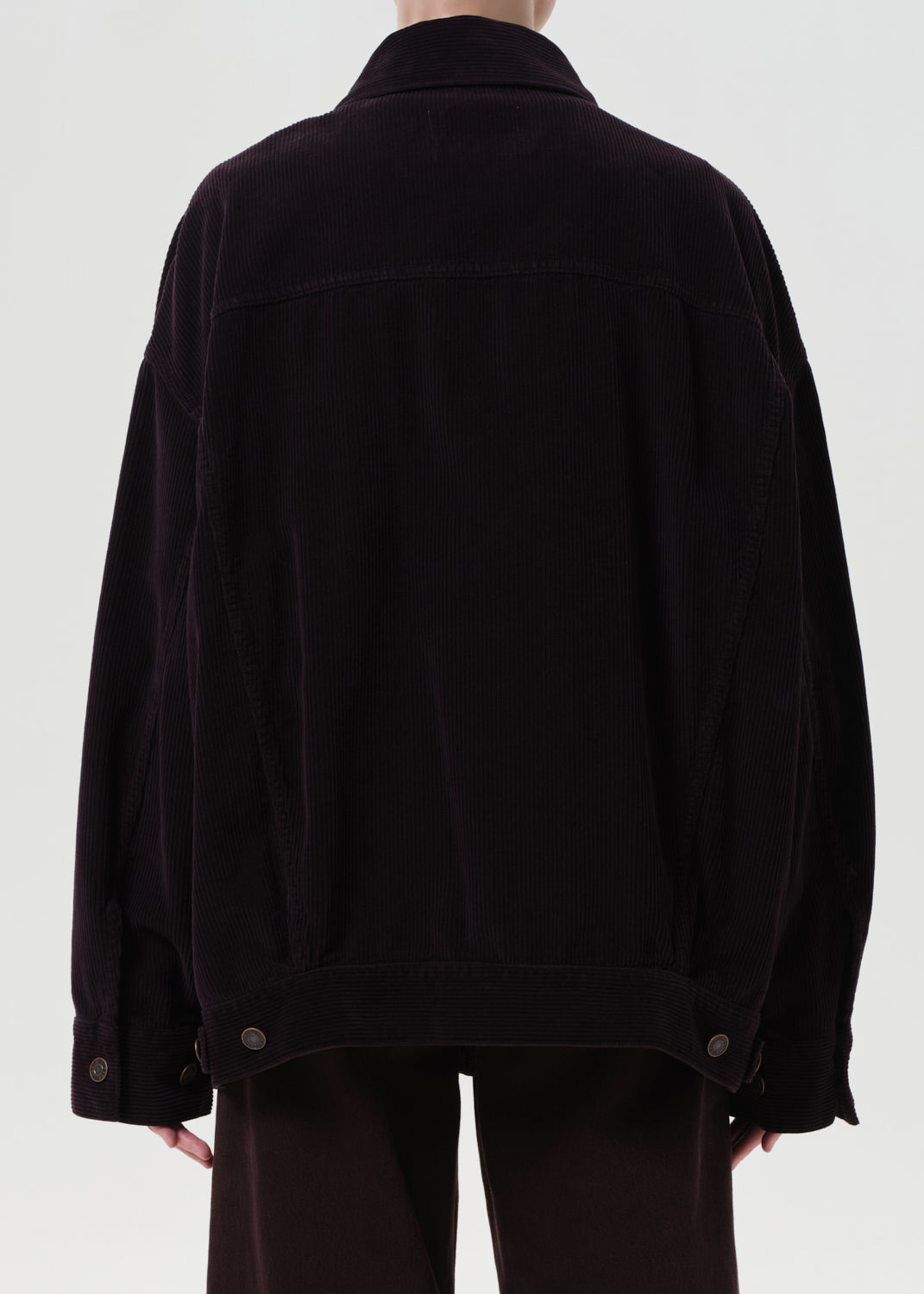 Person wearing a black jacket on a white background
