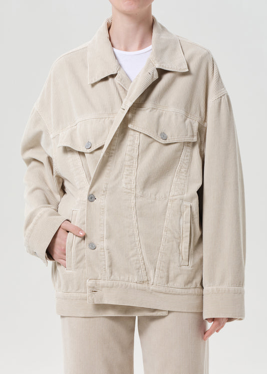 Person wearing a beige corduroy jacket on a white background