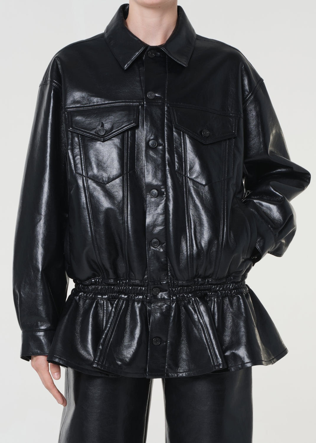 Black leather jacket with peplum waist on a white background