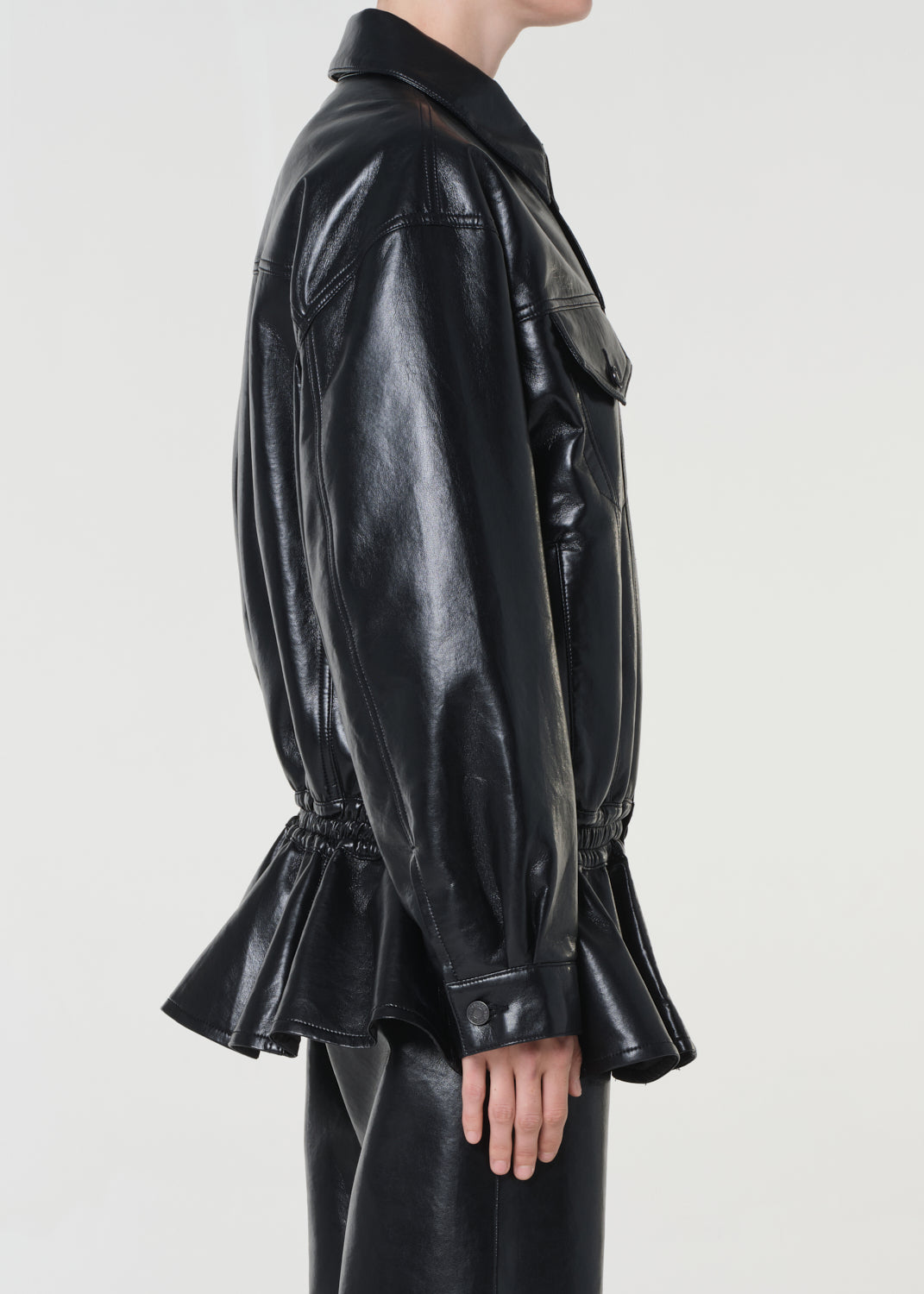 Black leather jacket with peplum detail on a white background