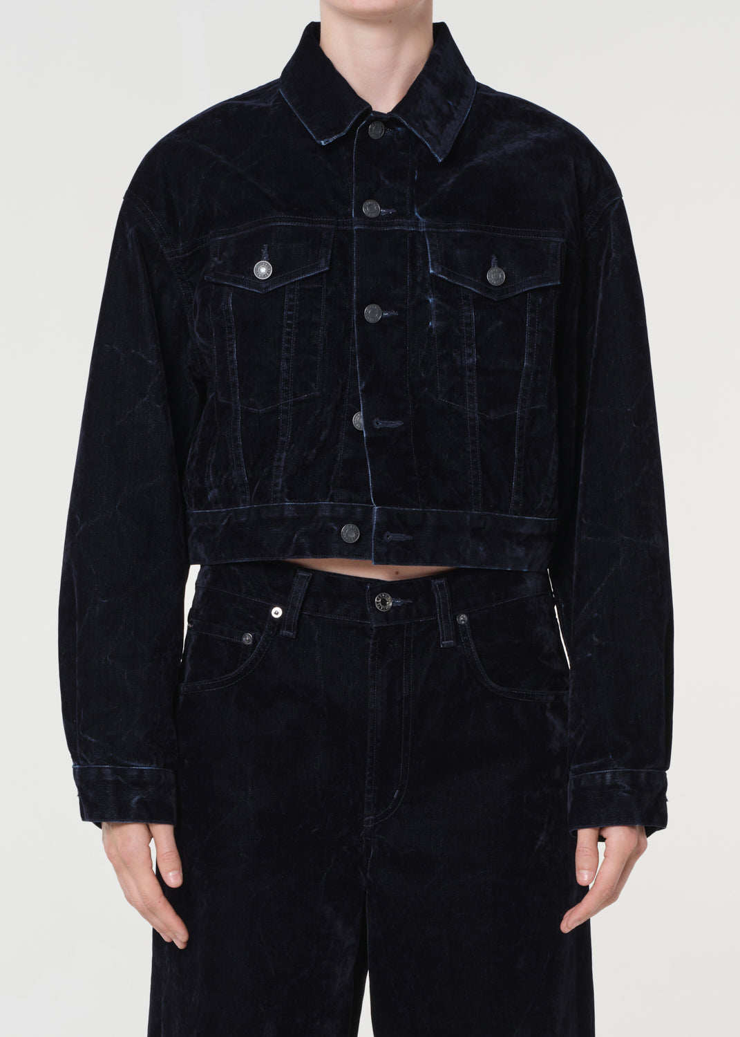 Blue corduroy jacket and pants on a white background