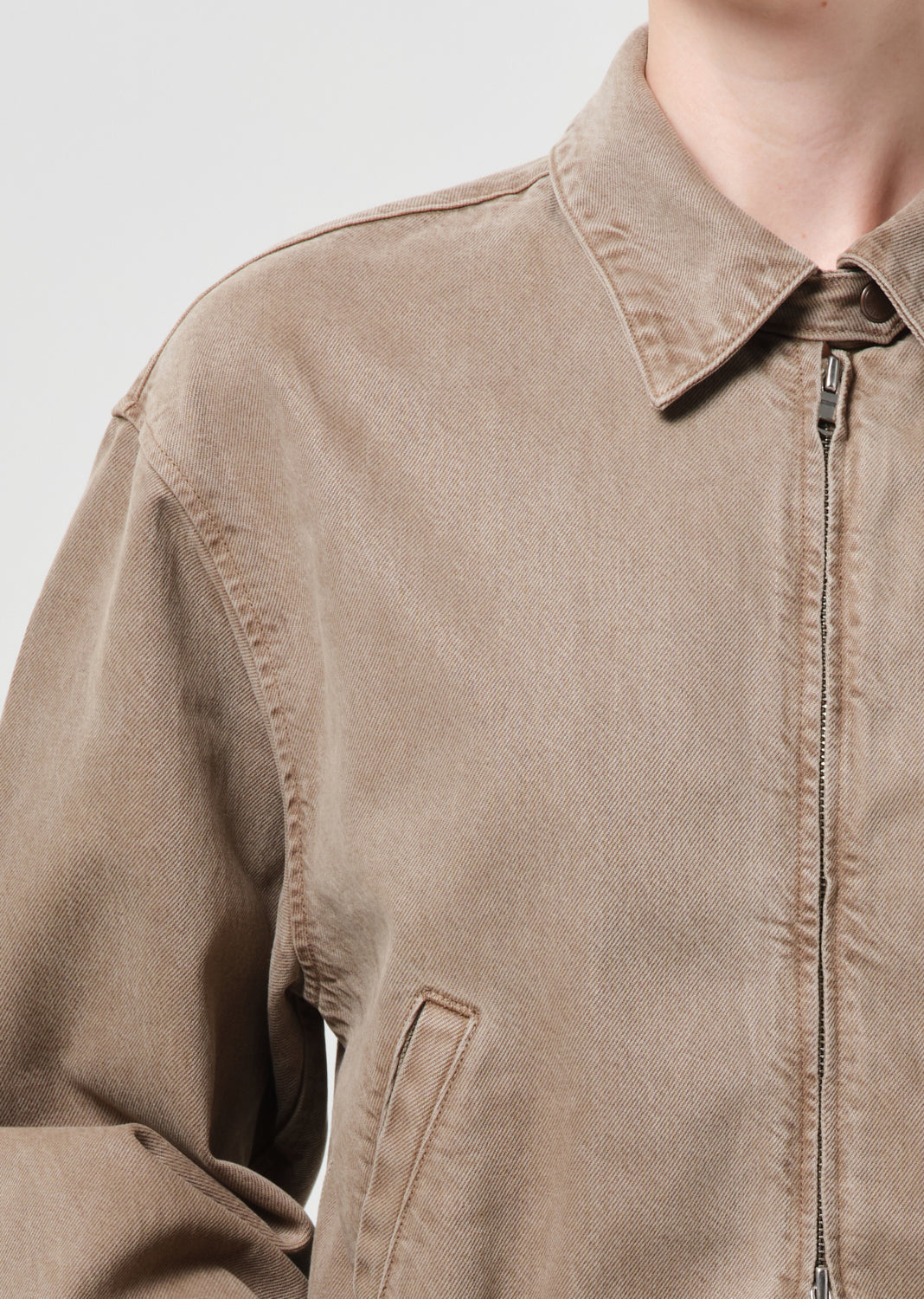 Close up of person wearing brown jacket