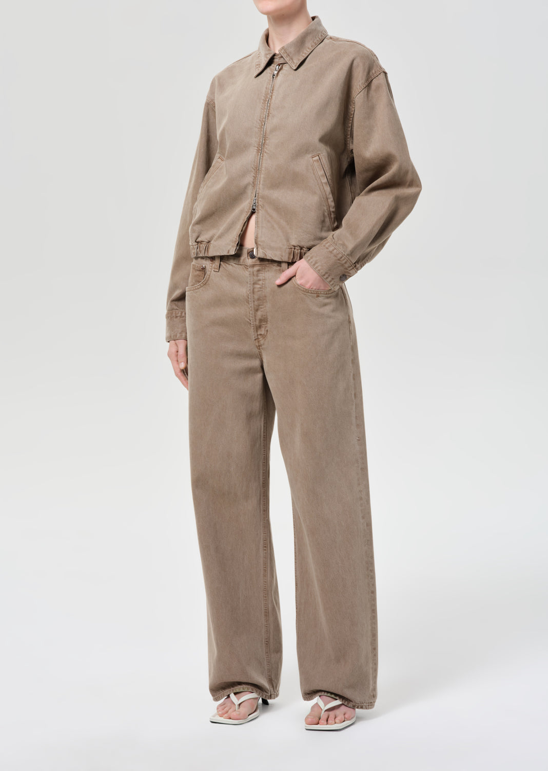 Person wearing a brown jacket and brown pants