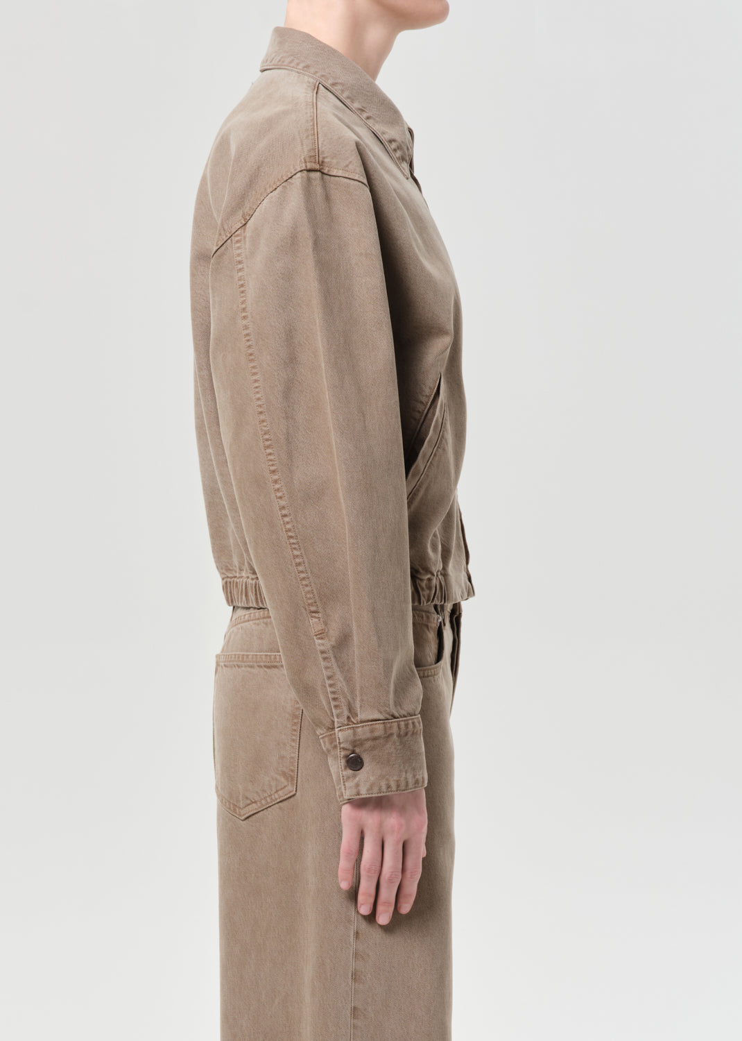 Side close up of person wearing brown jacket