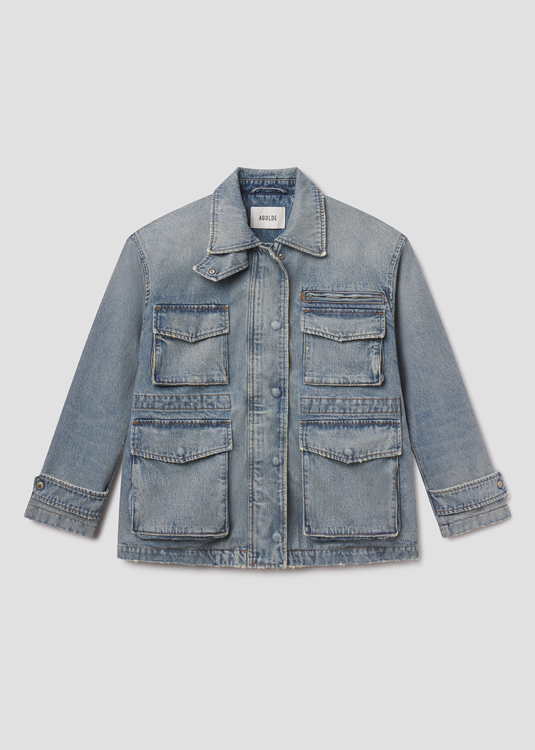 Blue denim jacket with multiple pockets on a light gray background