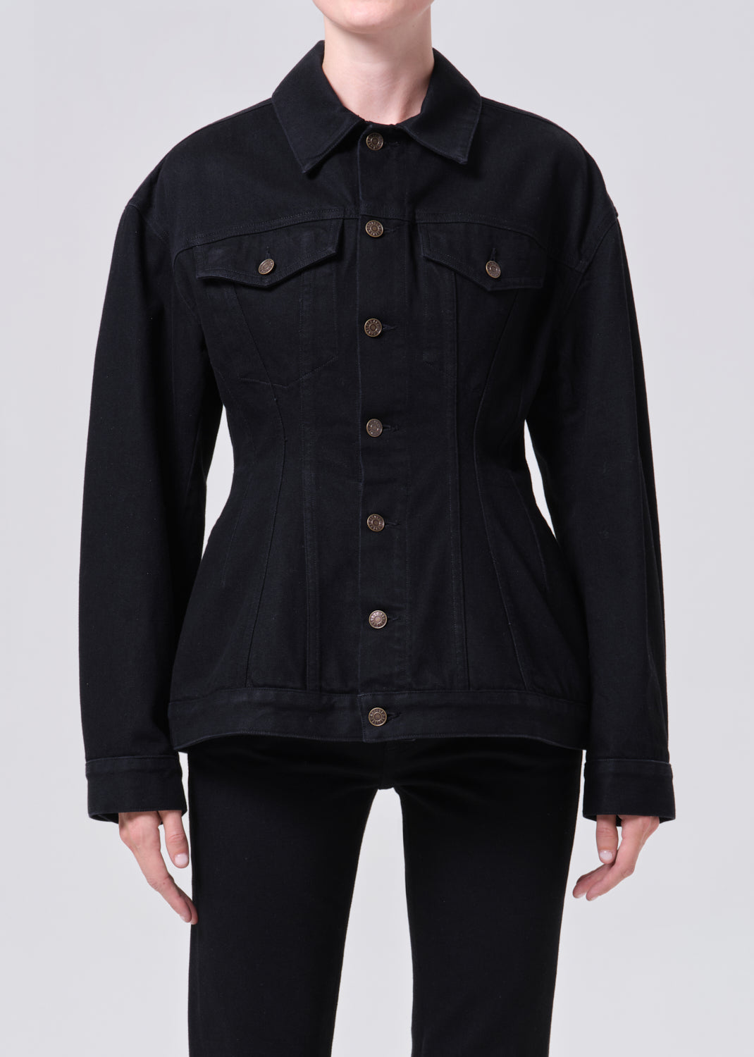 Black denim jacket with button details on a white background