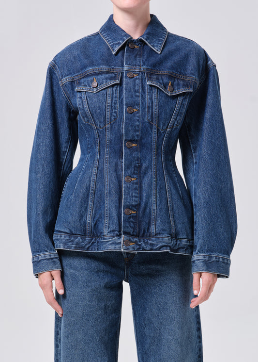 Blue denim jacket worn by a person on a light gray background