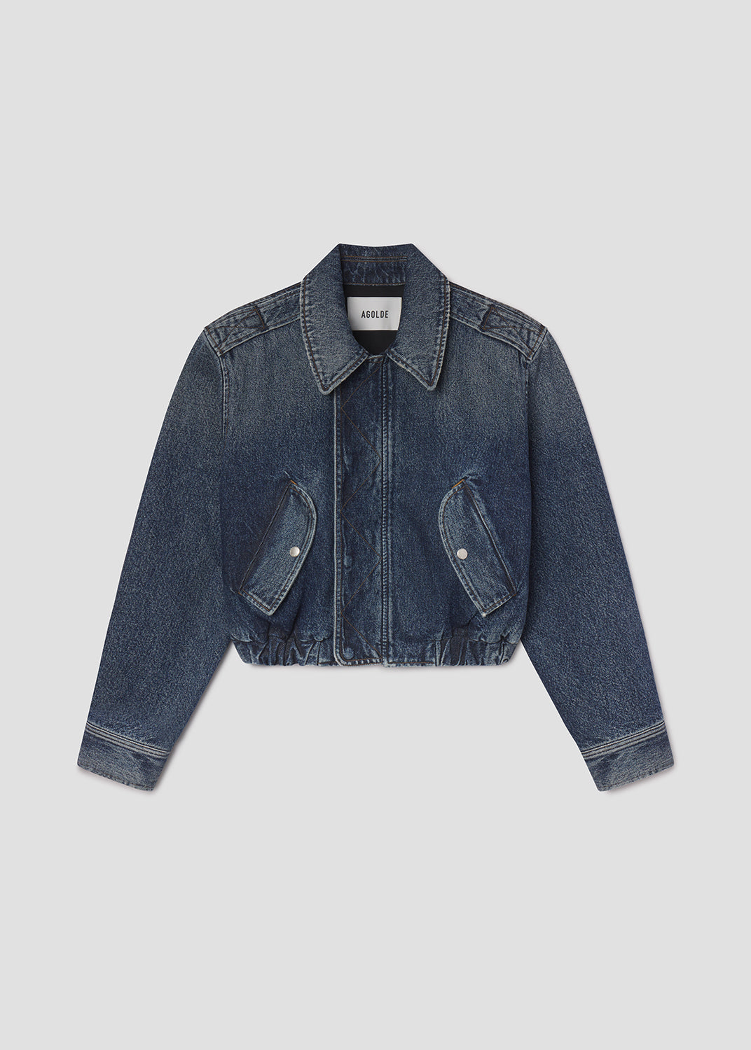 Blue denim jacket on a light gray background