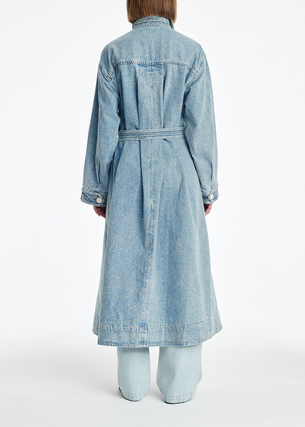 Light blue denim dress worn by a person on a white background