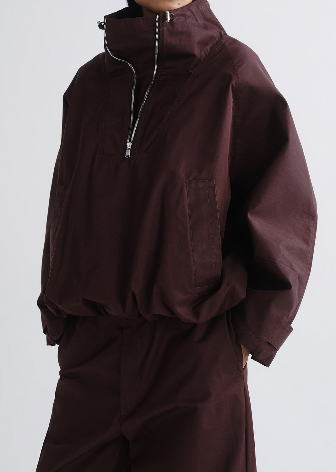 Brown jacket and pants set on a grey background