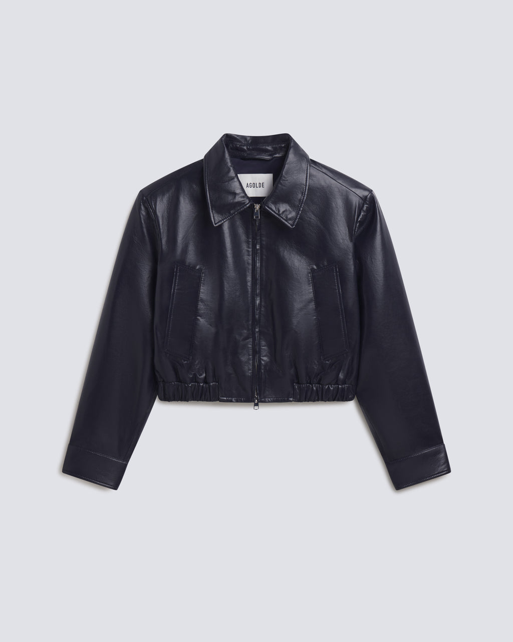 A cropped black faux-leather jacket with a zippered front, pointed collar, and long sleeves, shown flat on a white background.