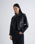 Person wearing a black leather jacket on a white background