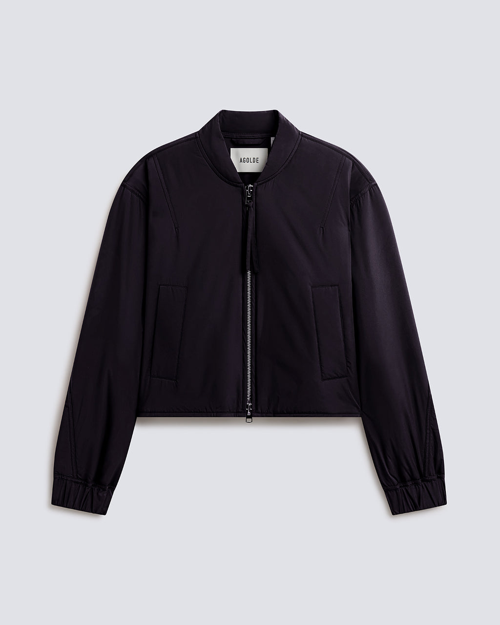 A black cropped zip-up jacket with a stand collar, long sleeves, and two front flap pockets, shown flat against a light gray background.