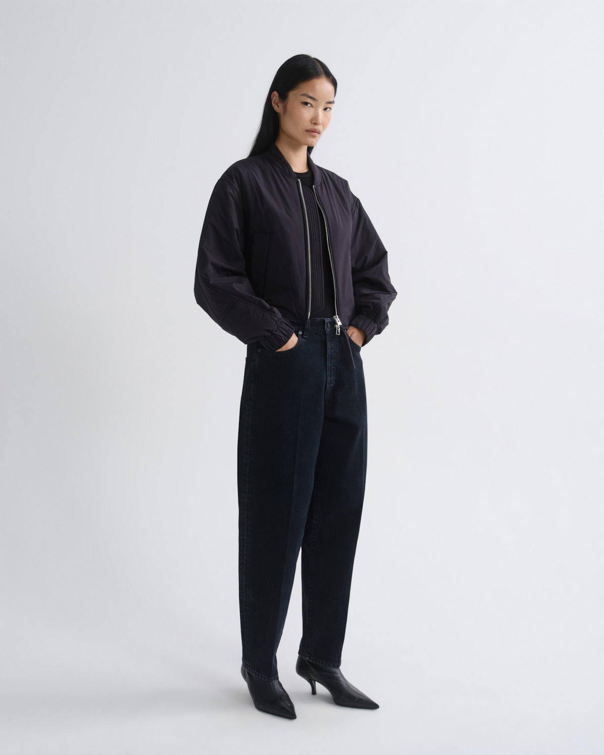 Person wearing a black outfit on a white background