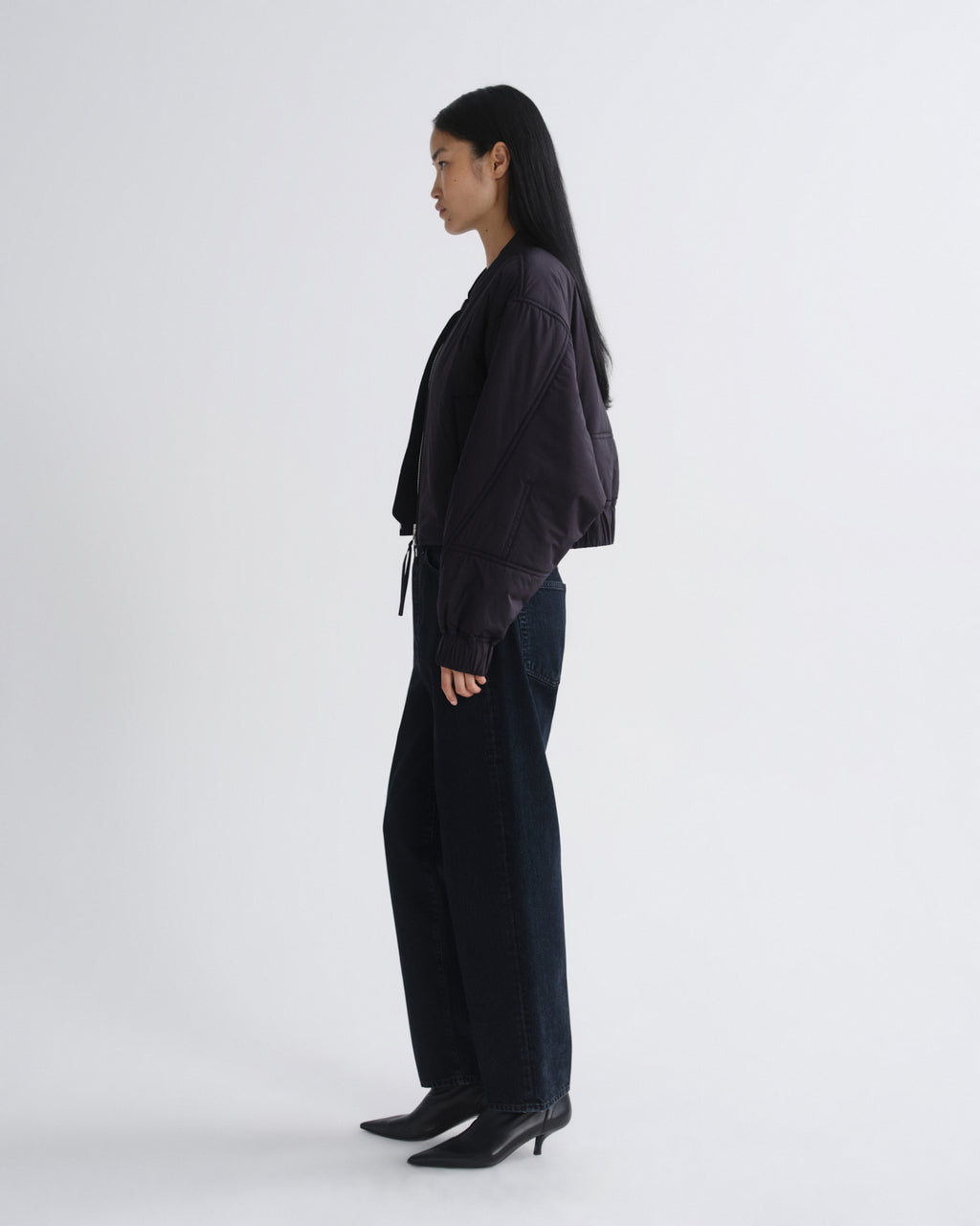 Person wearing a black outfit on a white background